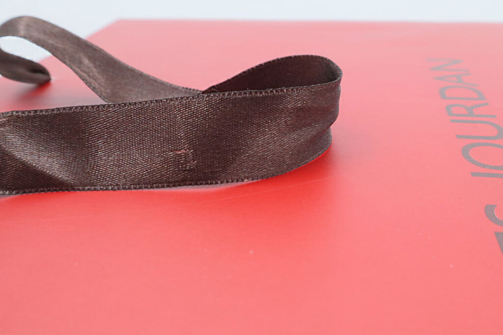 Red paper bag with brown satin handles