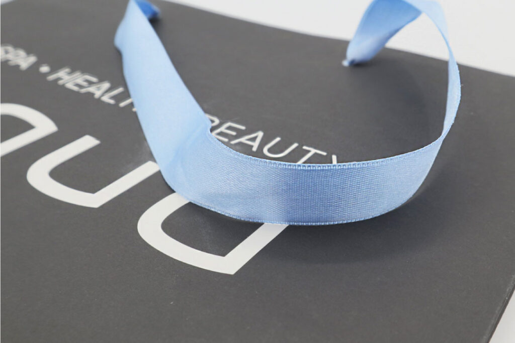 Gray paper bag with babyblue satin handles